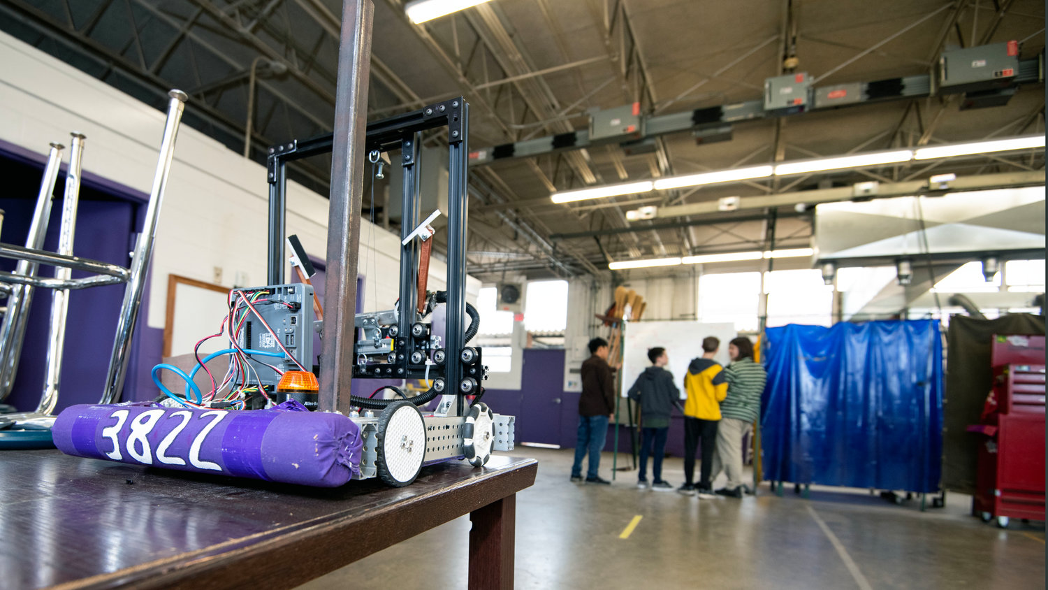 A miniature robot, built last year by students at the Chatham School of Science & Engineering and Jordan-Matthews High School, sits on a table during the school’s robotics team's first meeting of 2023. The Neon Krakens won an award for their 2022 design. .